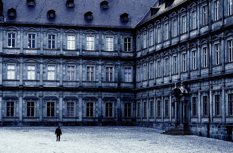 person in courtyard of historic building