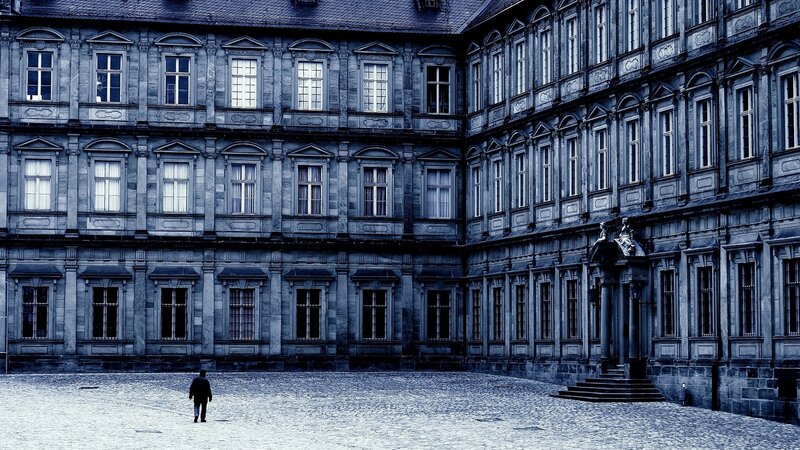 person in courtyard of old building