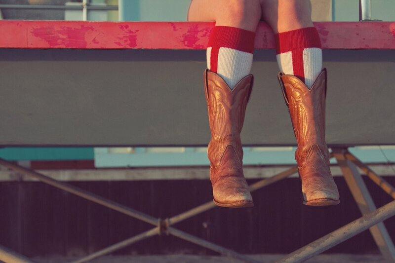 person in cowboy boots and socks