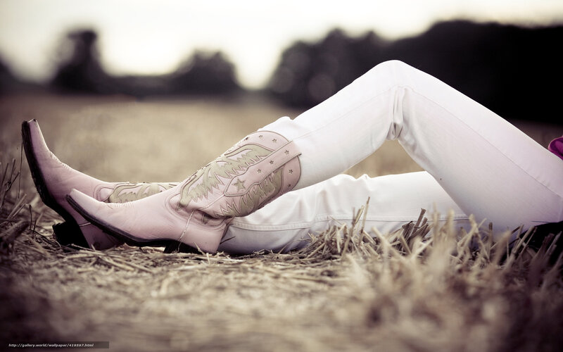 person in cowboy boots lying down