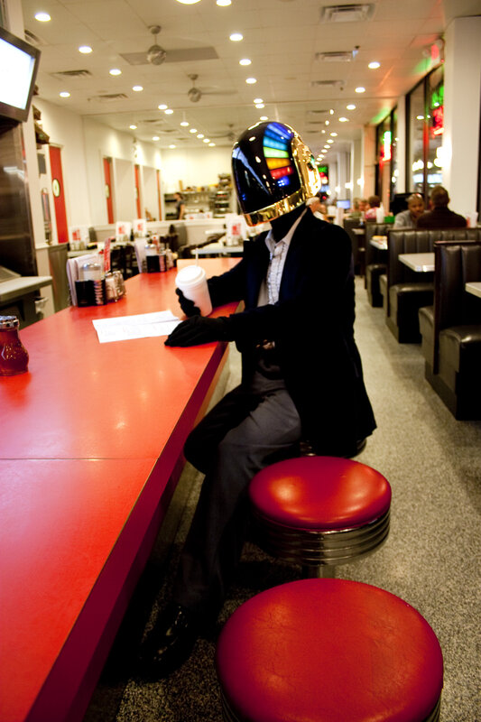 person in daft punk helmet at diner
