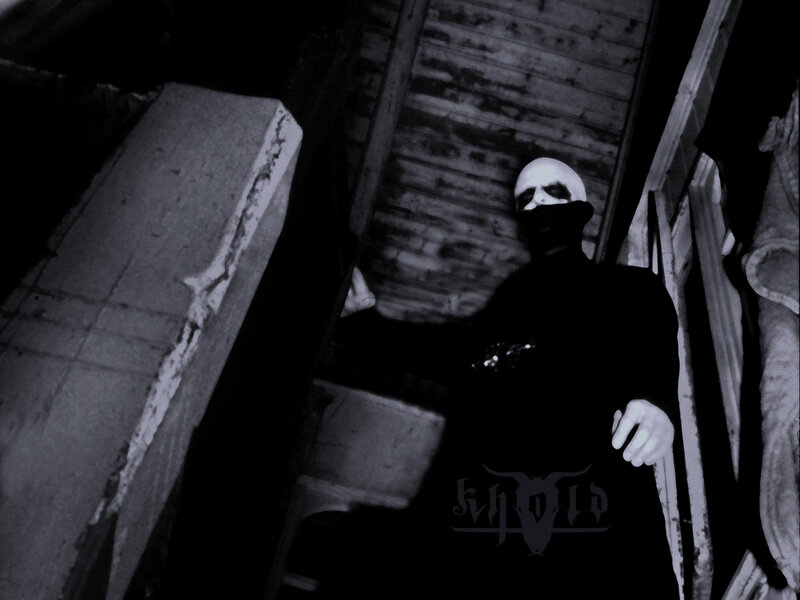 person in dark alley with mask