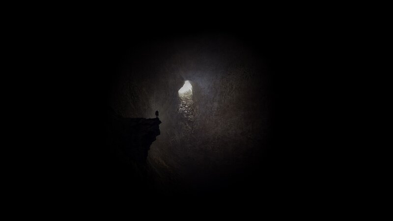 Person in Dark Cave — Black, Dramatic, Photograph