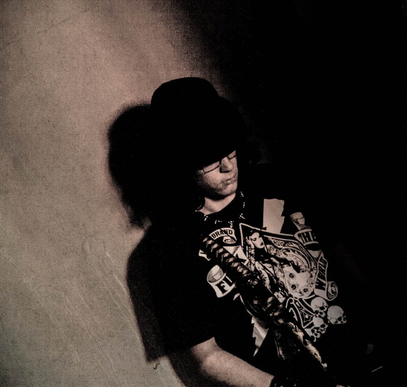 person in dark clothing with graphic t-shirt