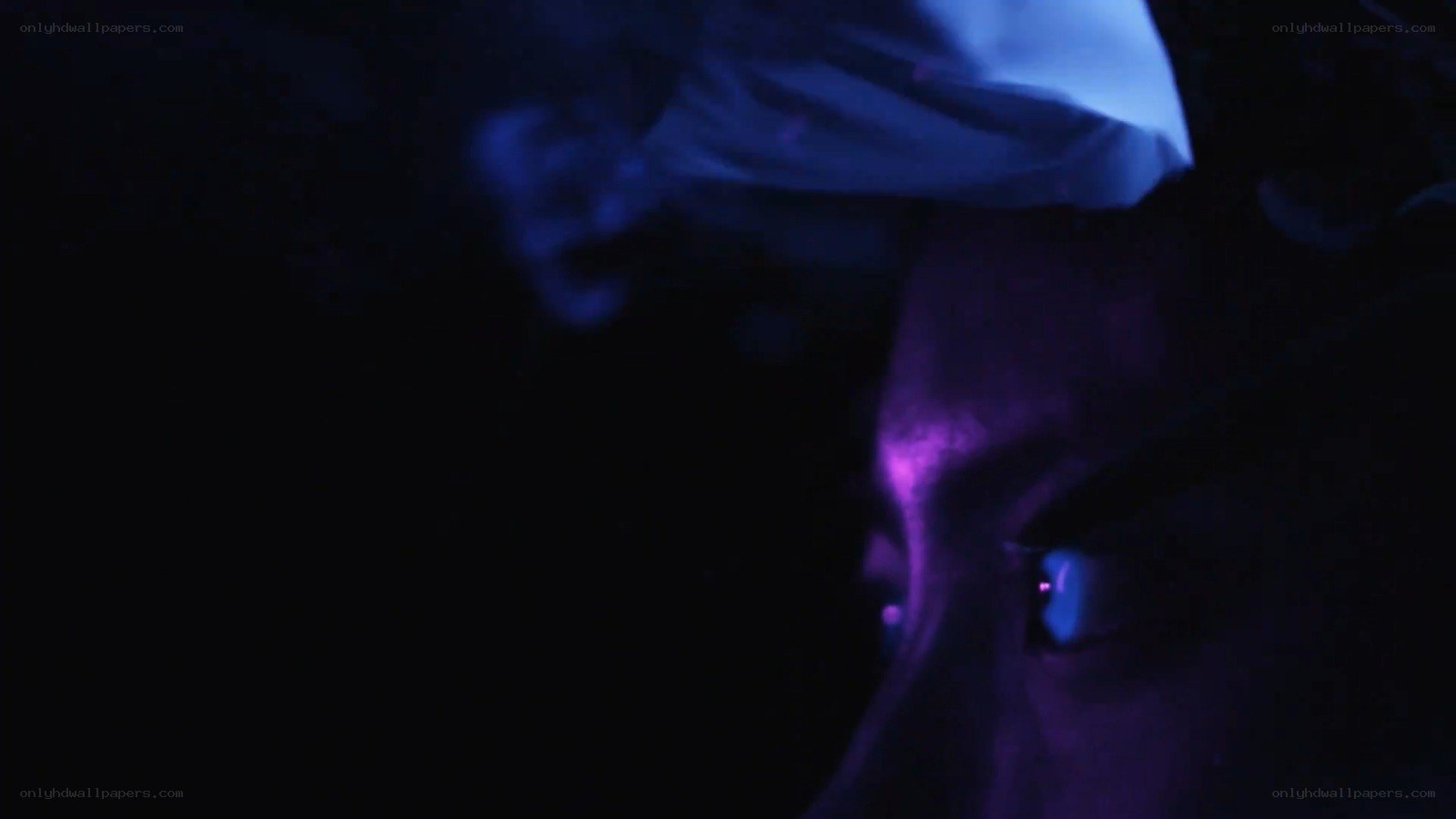 person in dark with blue light