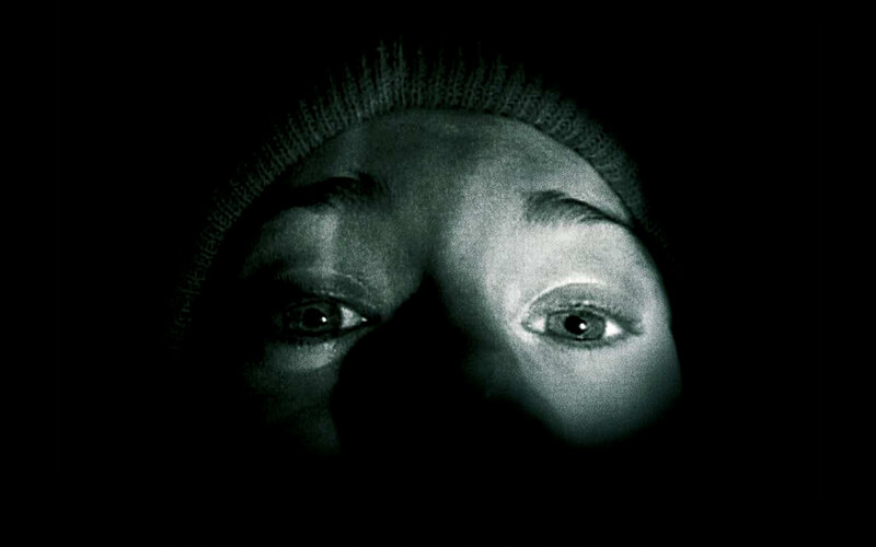 person in dark with glowing eyes