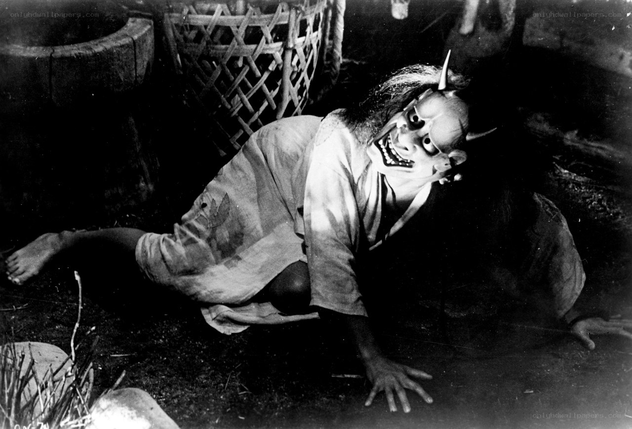 person in demon mask on ground