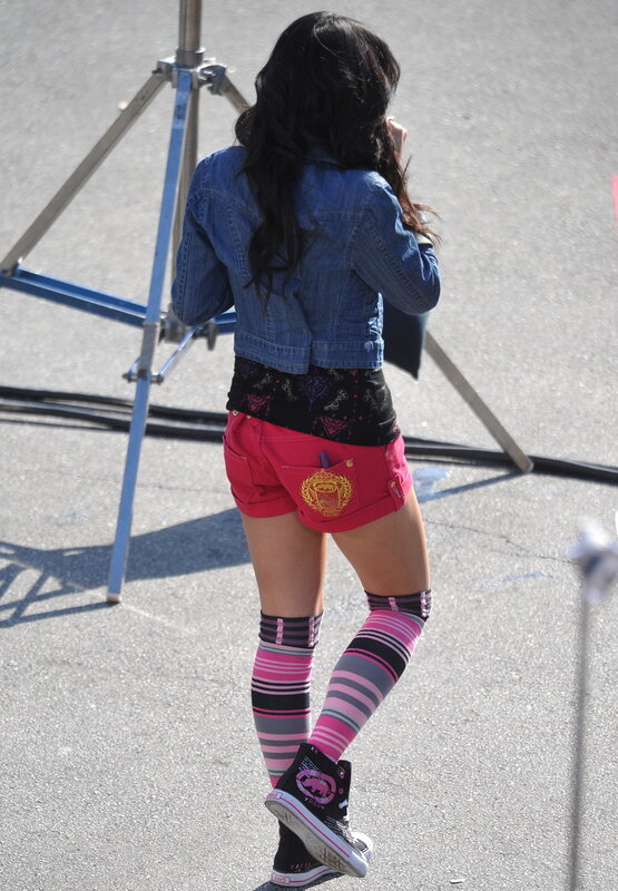 person in denim jacket and pink shorts