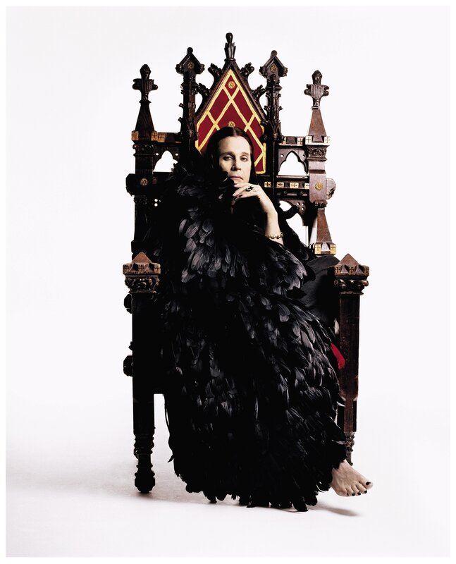person in feathered cloak on throne