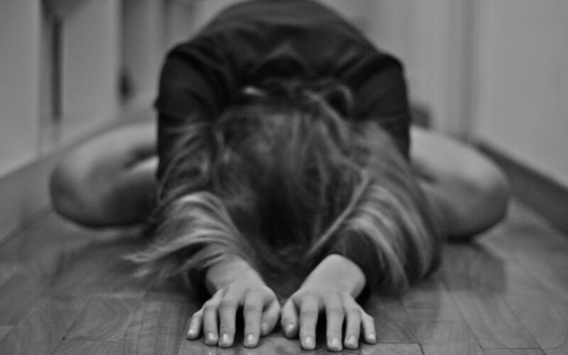 person in fetal position on floor