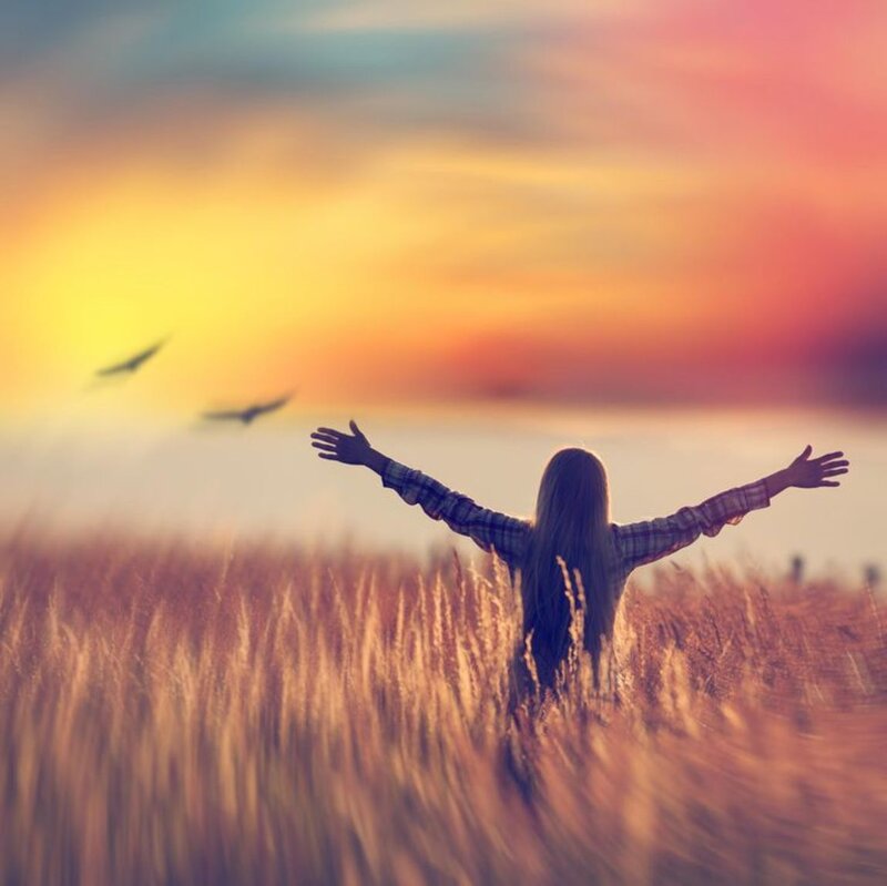 Person in Field with Arms Outstretched