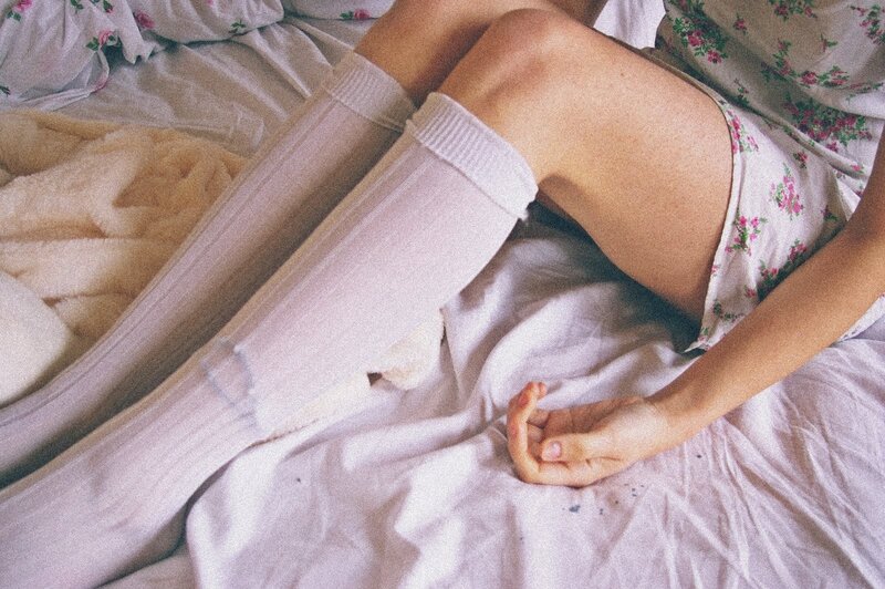 person in floral dress on bed