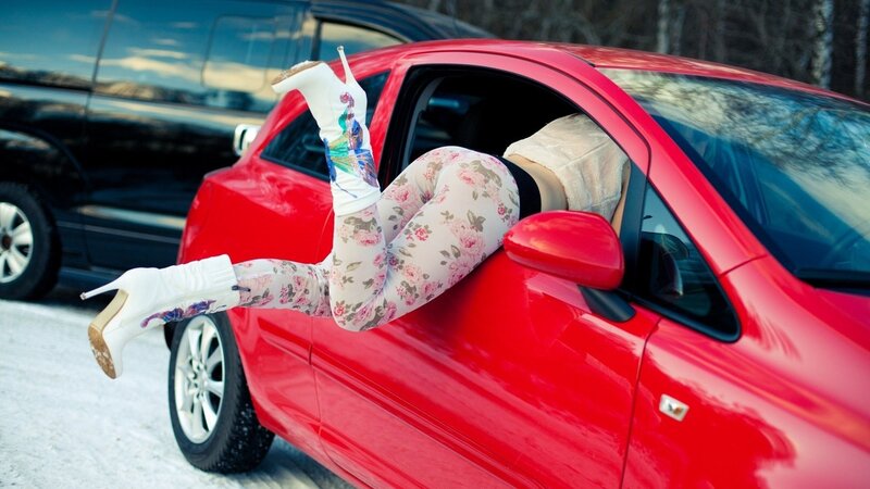 person in floral leggings exiting car