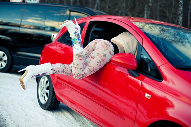 Person in floral leggings exiting car