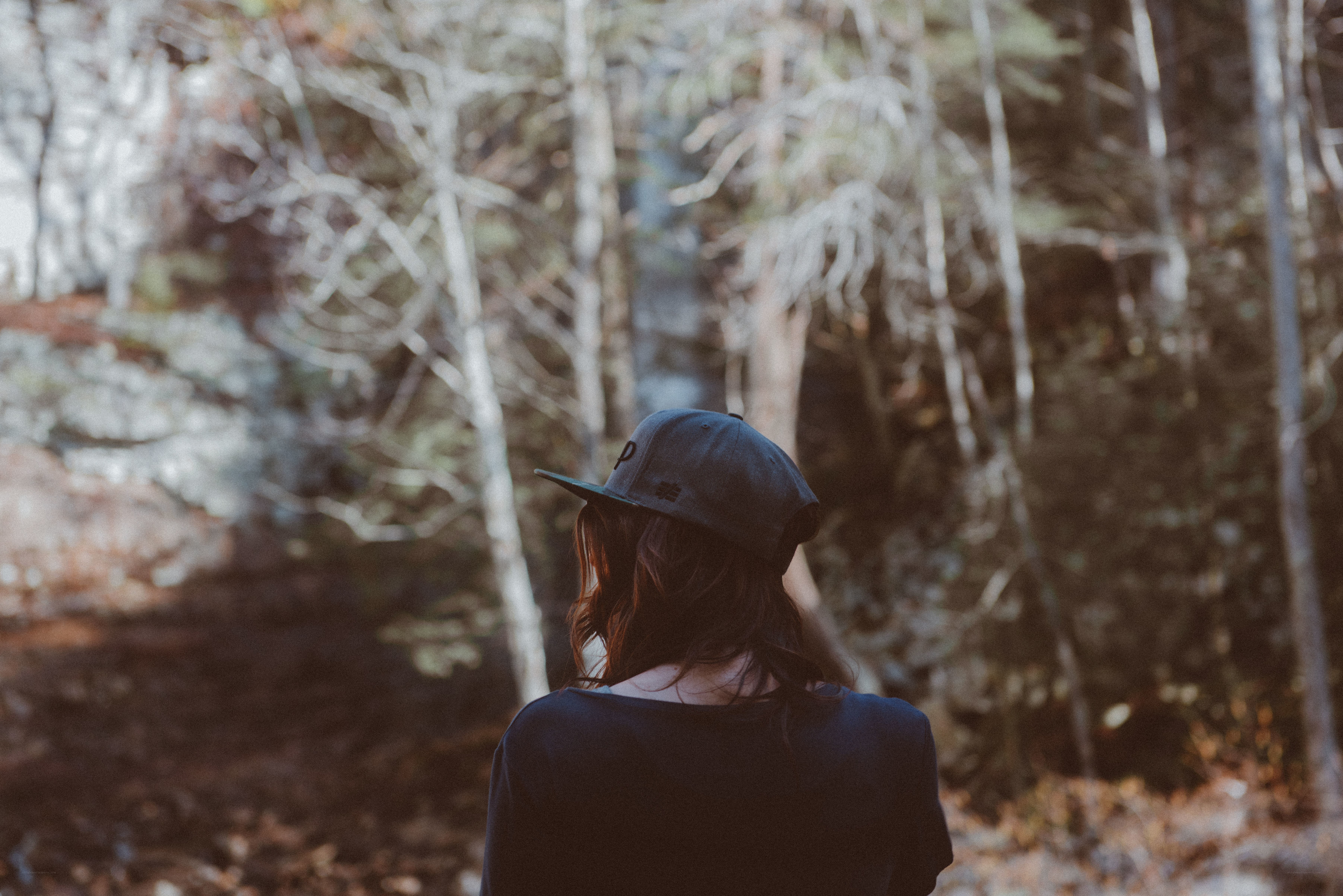 Person in forest wearing cap