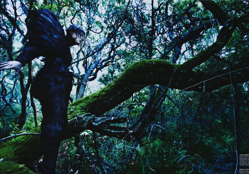person in forest with mossy branch