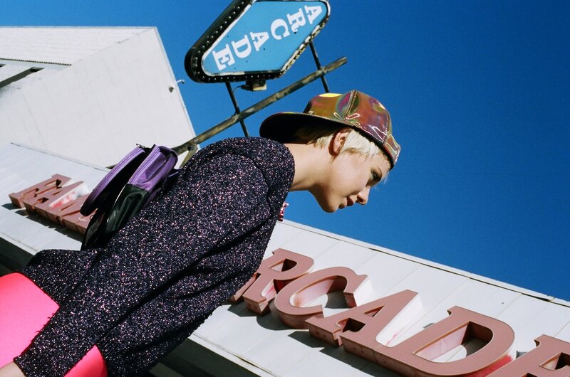 Person in front of arcade sign