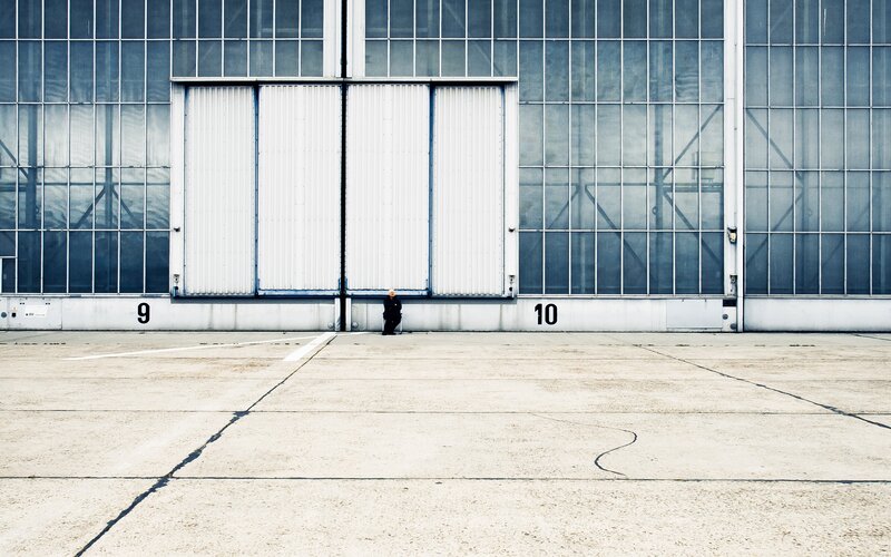 Person in Front of Hangar
