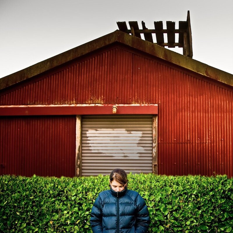 Person in front of red shed