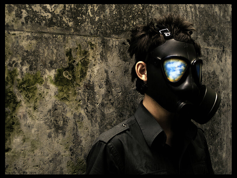 person in gas mask against wall