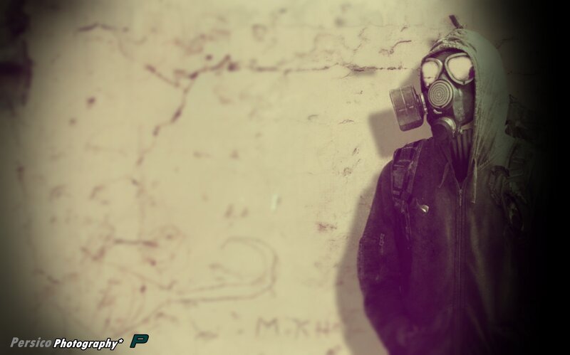 person in gas mask against wall