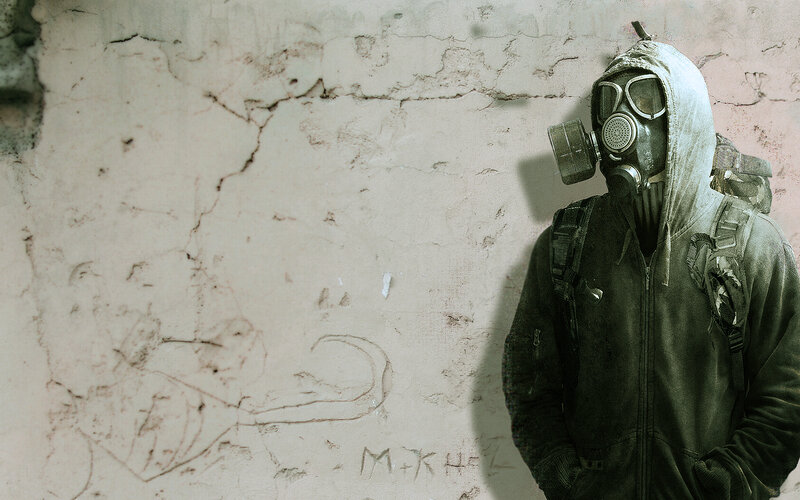 person in gas mask against wall