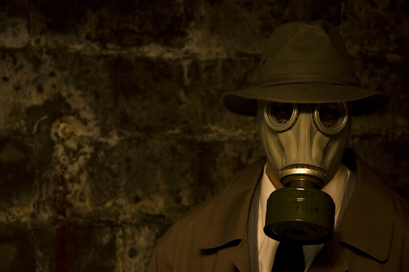 person in gas mask and hat