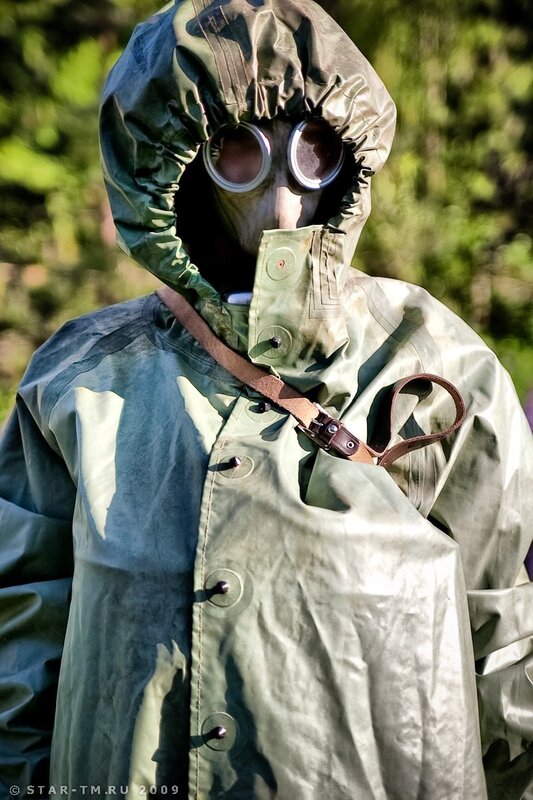 person in gas mask and protective suit