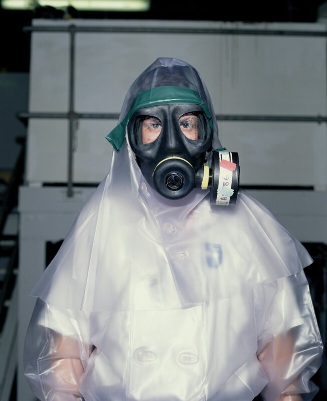 person in gas mask and protective suit