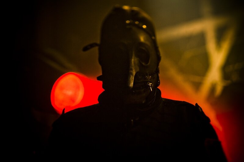 person in gas mask at concert
