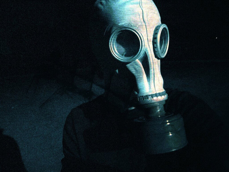 person in gas mask at night