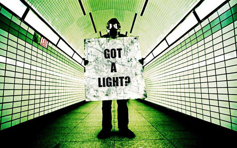 person in gas mask holding sign