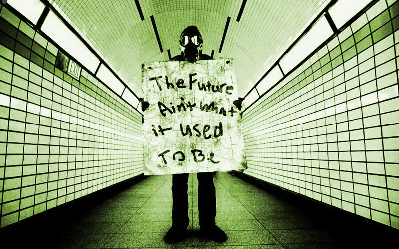 person in gas mask holding sign