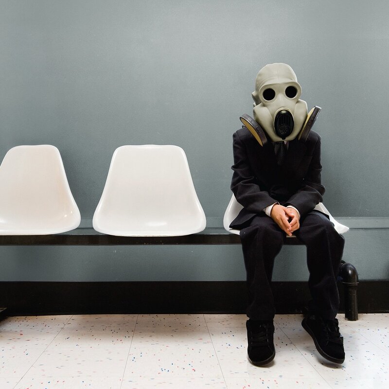 person in gas mask on bench