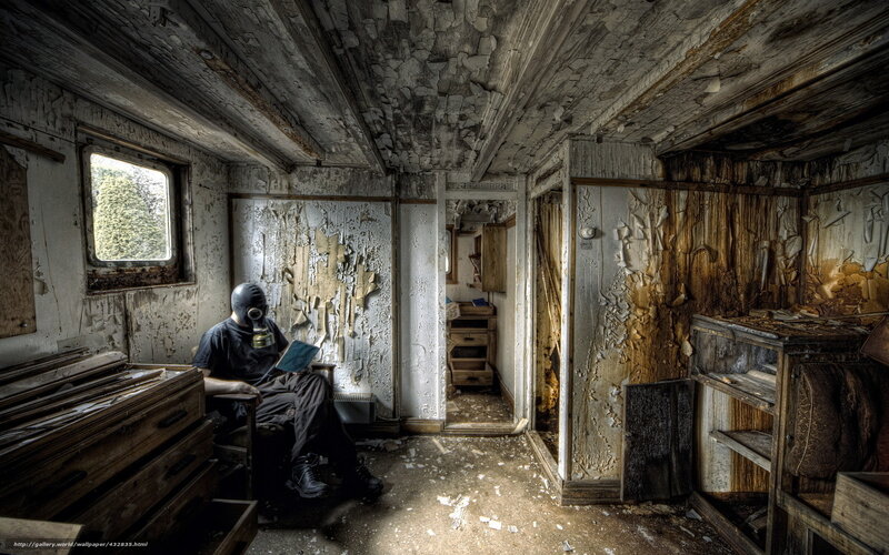 person in gas mask reading