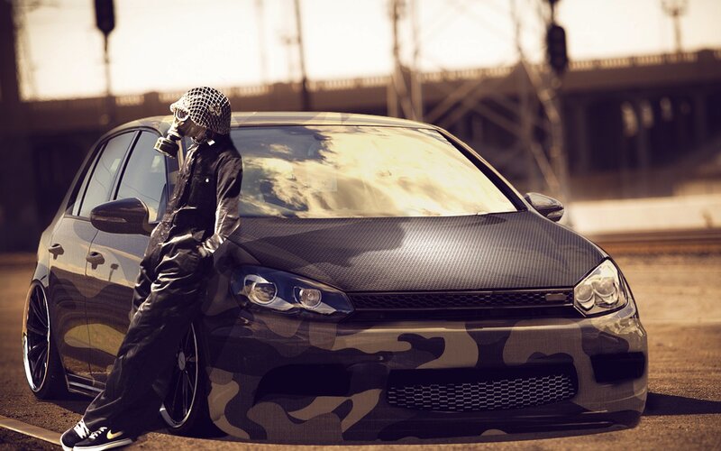 person in gas mask with camo car