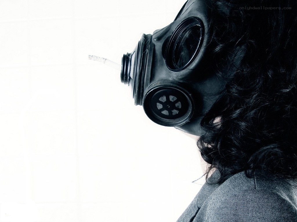 person in gas mask with cigarette