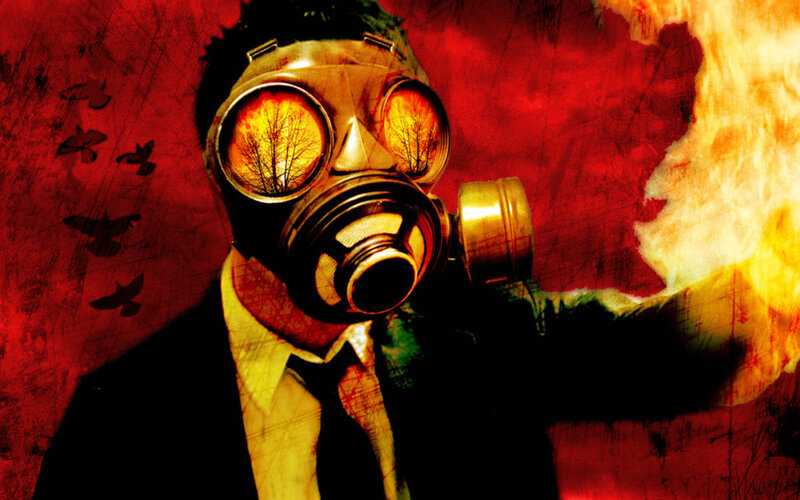 person in gas mask with fire