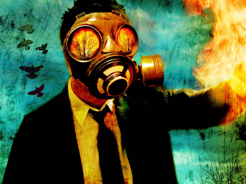 person in gas mask with fire