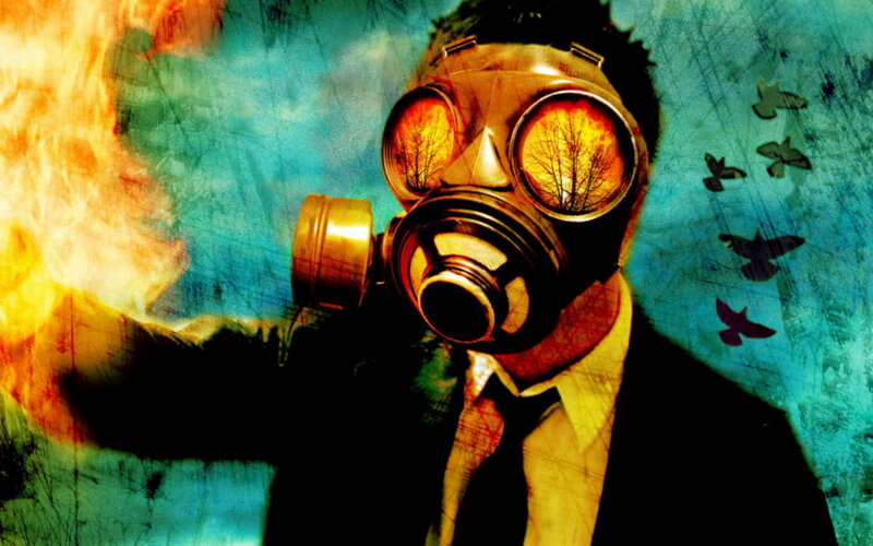 person in gas mask with fire