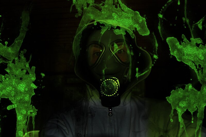 person in gas mask with green splatter