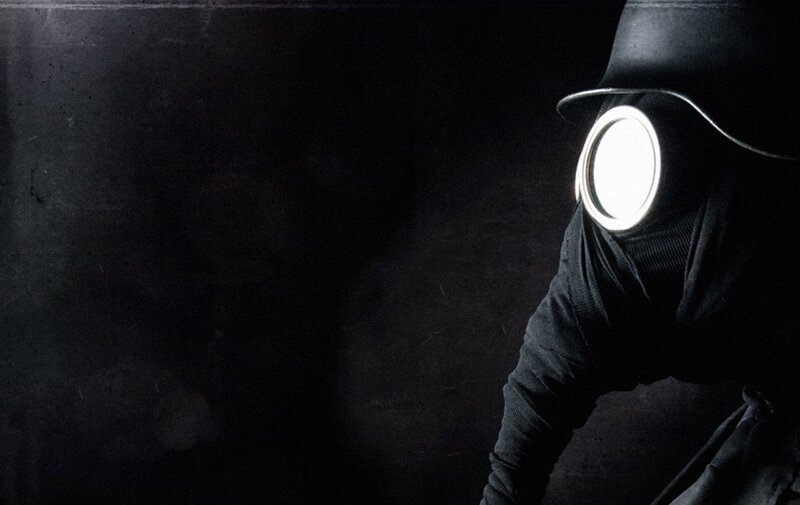 person in gas mask with light