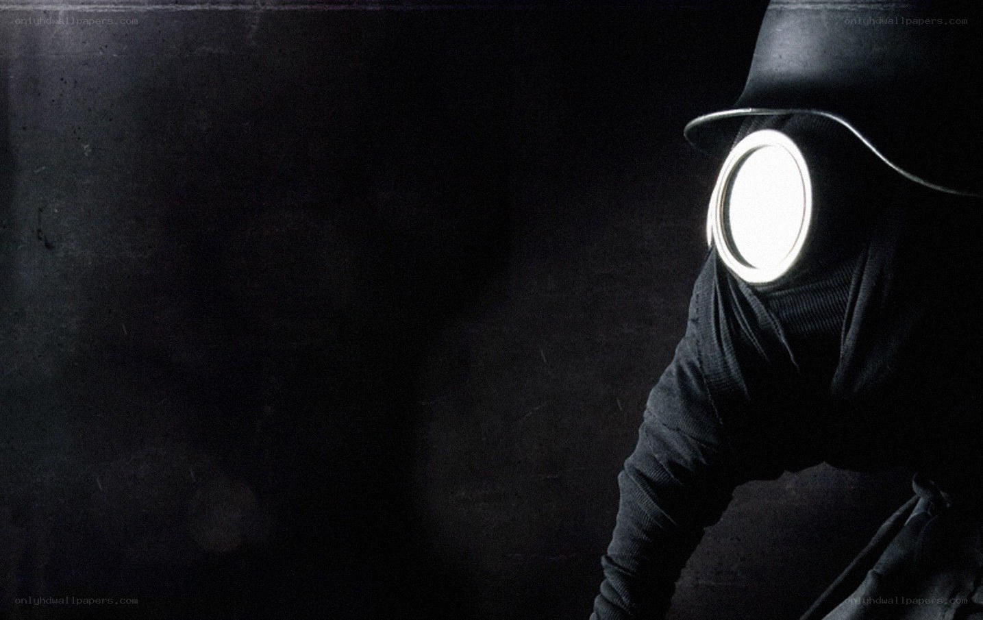 person in gas mask with light