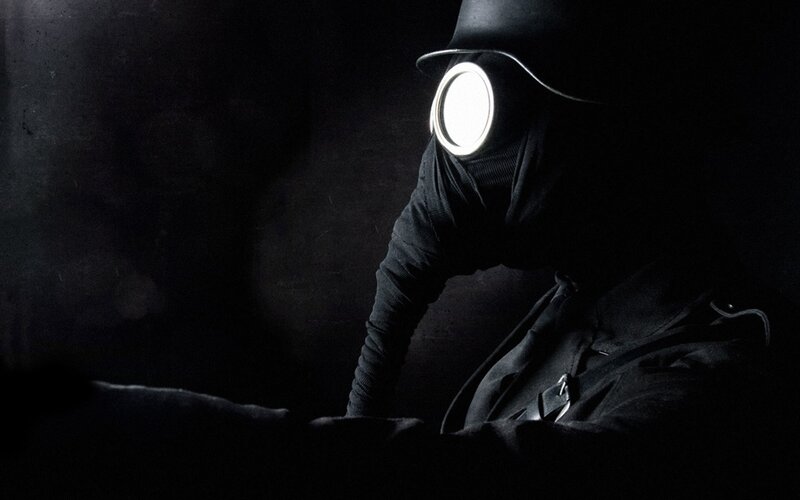person in gas mask with light