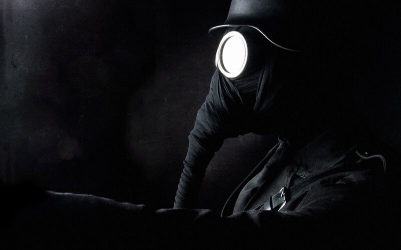 person in gas mask with light
