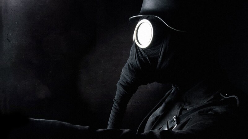 person in gas mask with light