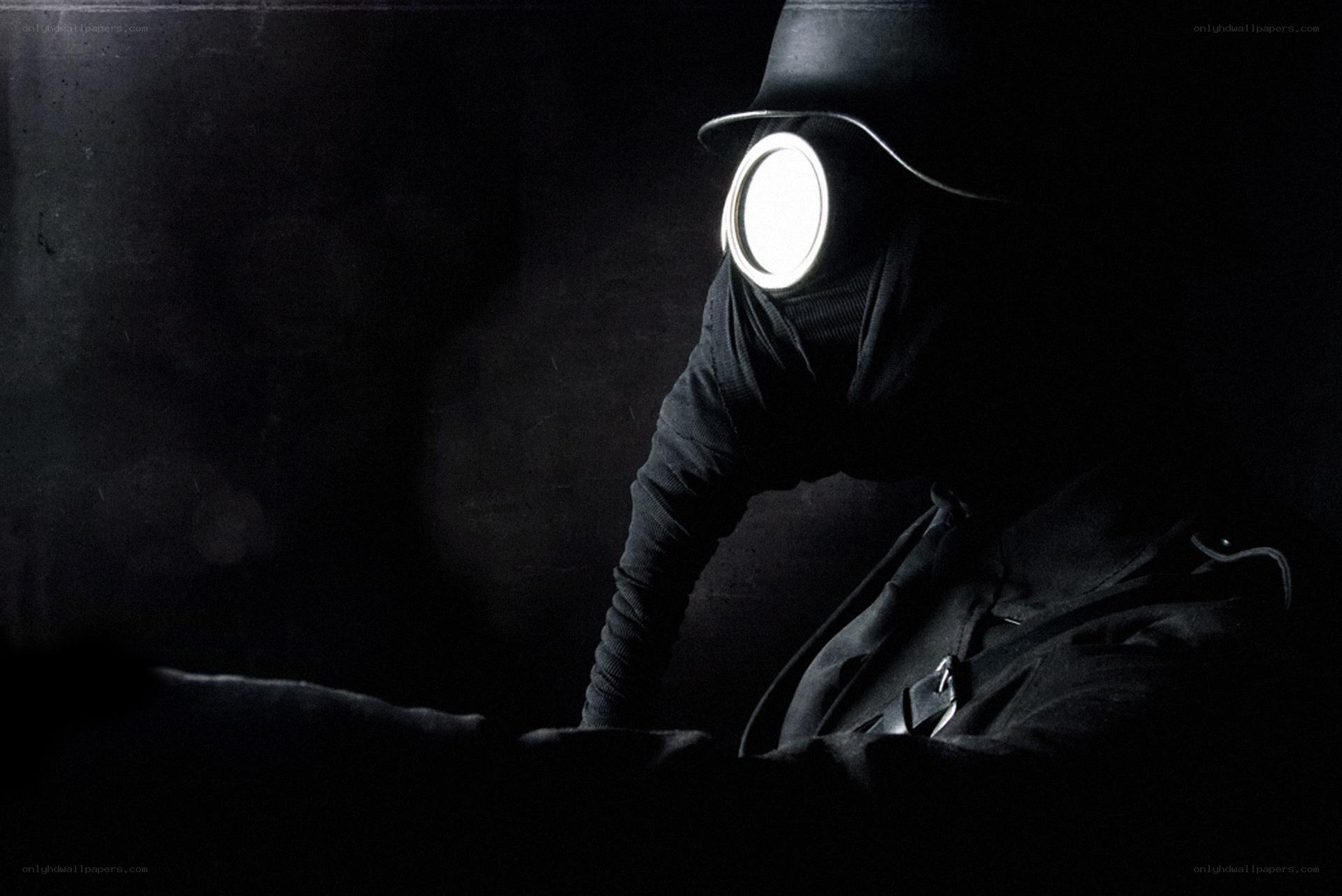 person in gas mask with light