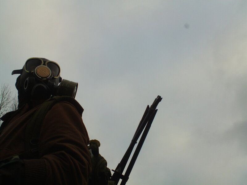 person in gas mask with rifle