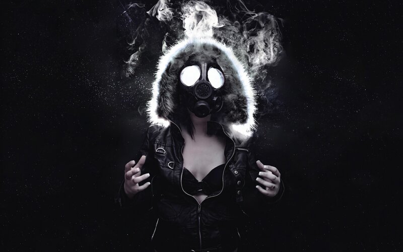 person in gas mask with smoke