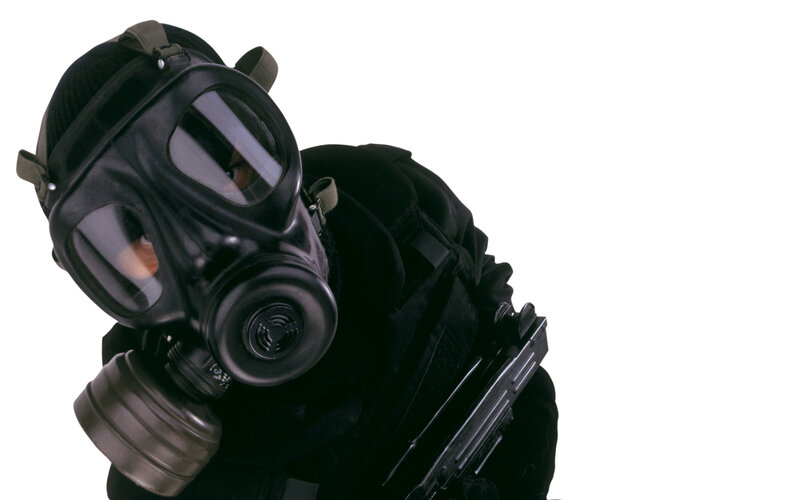 person in gas mask with weapon